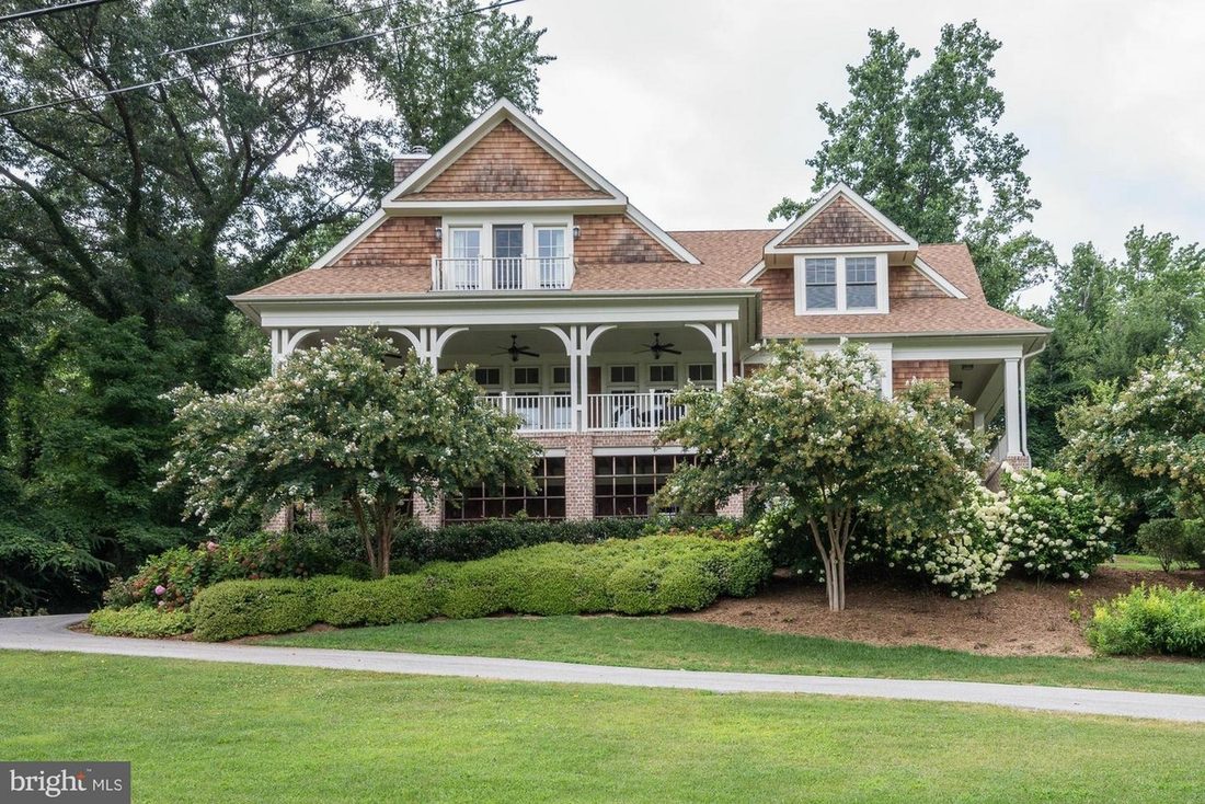 Front elevation of the Gibson Island shingle residence with its columned wraparound porch.